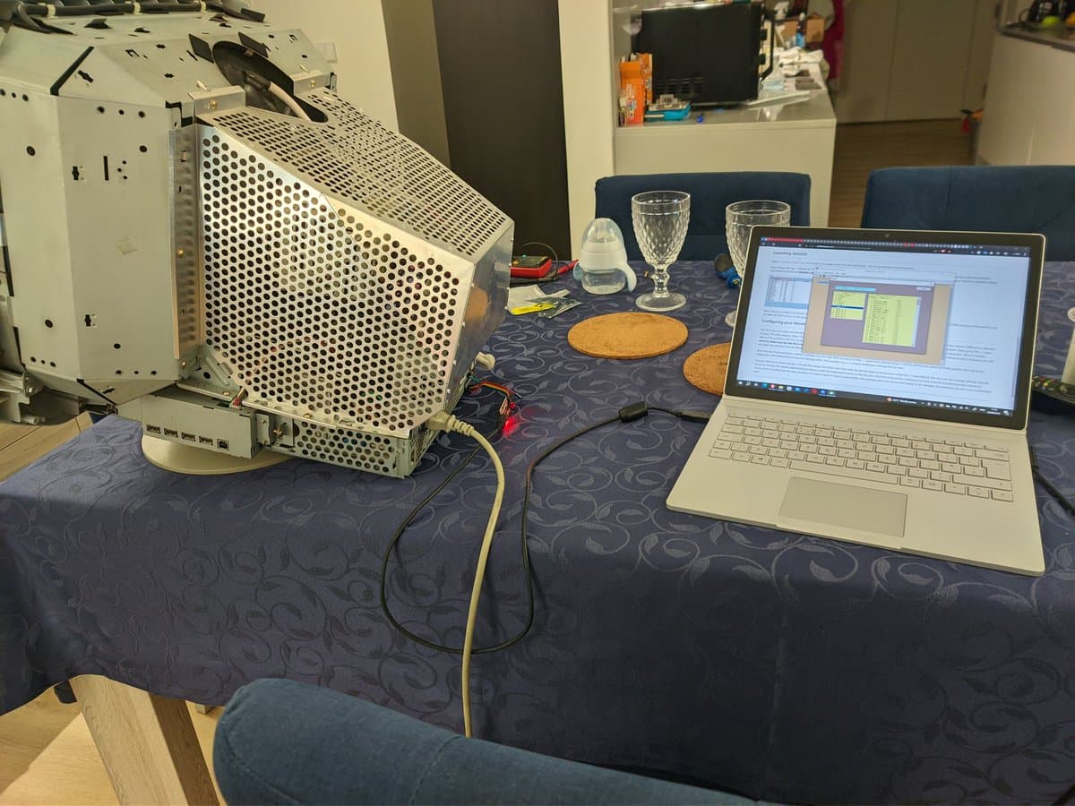 Sony CPD-G420 CRT monitor on desk connected to laptop running WinDAS calibration software via USB-serial adapter for G2 voltage adjustment repair.