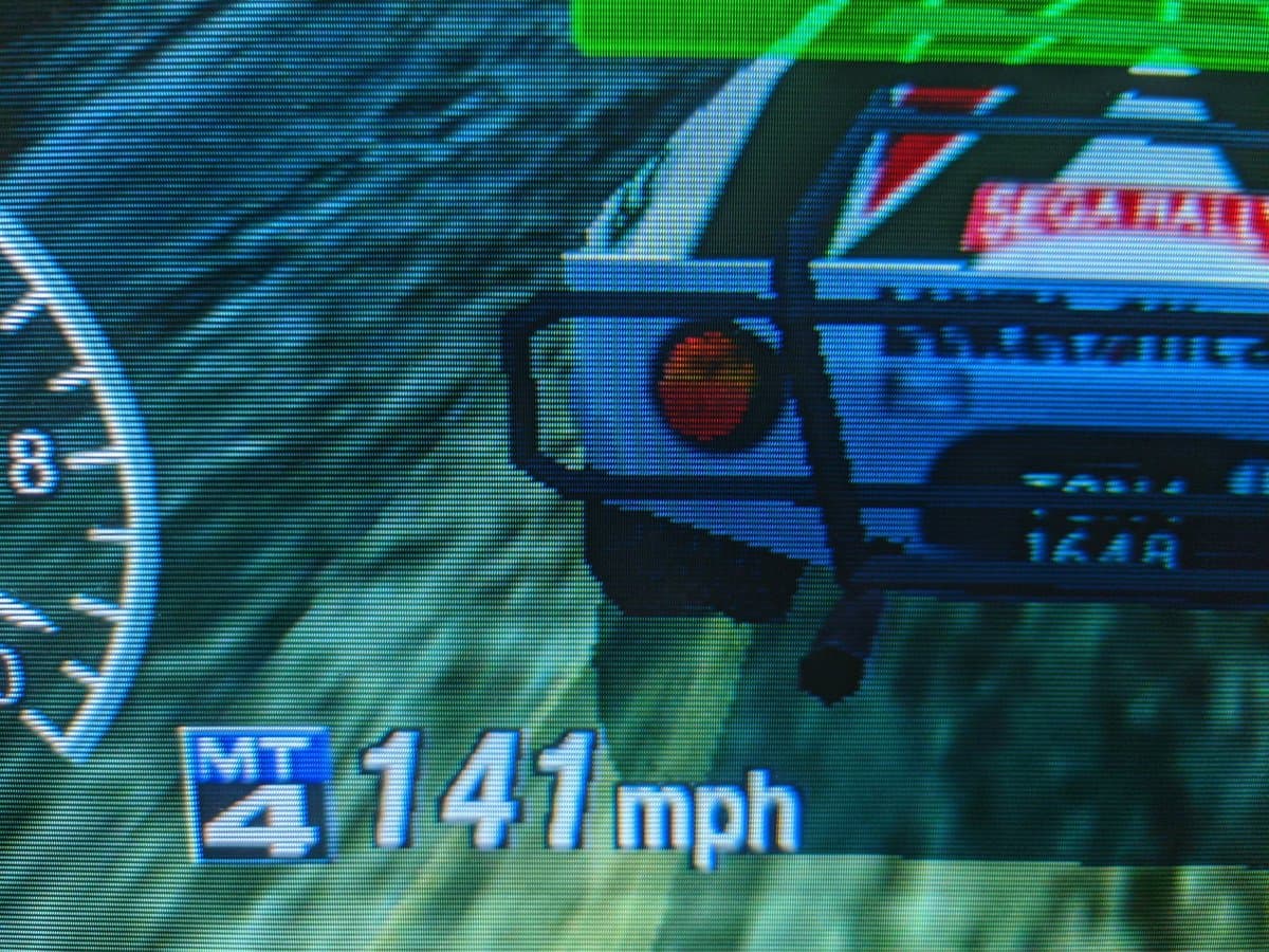 Sega Rally arcade game running on repaired Sony CPD-G420 CRT monitor showing 141 mph speedometer readout, geometry corrected via G2 voltage calibration.