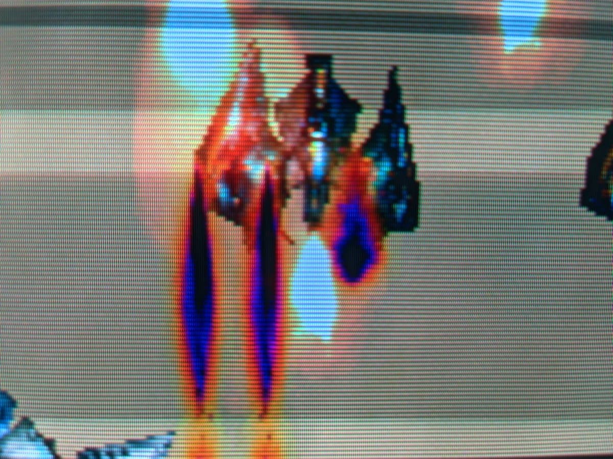 Ikaruga gameplay on Philips 109S4 CRT showing vibrant reds and blues with sharp aperture grille rendering and minimal bloom.