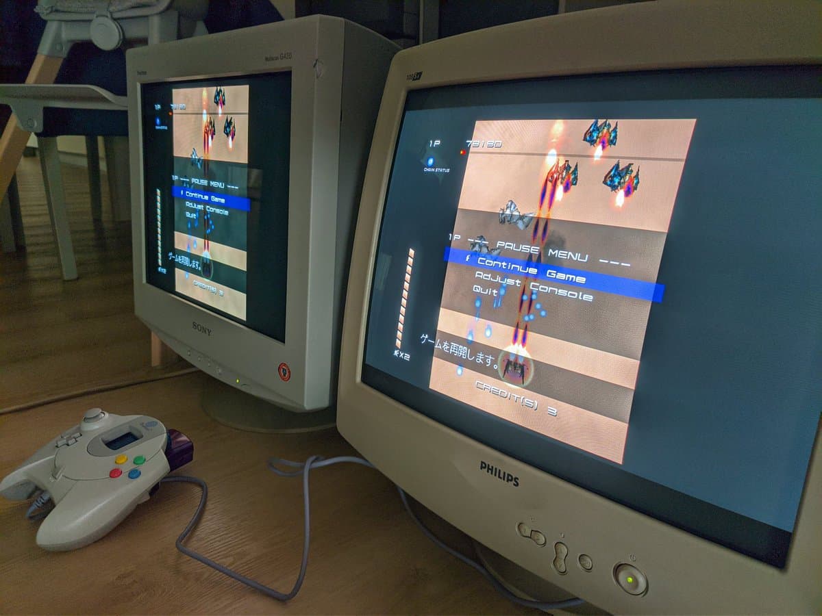 Philips 109S4 CRT displaying Ikaruga pause menu with aperture grille visible; Dreamcast controller and Sony CRT visible for comparison.