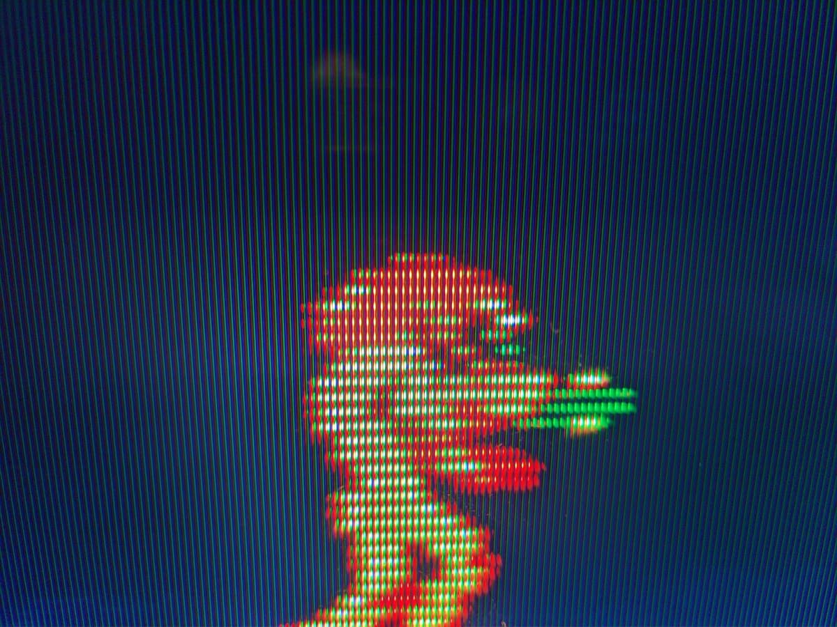 Pixelated Metroid sprite on Sony Trinitron displaying composite video from Famicom with visible scanlines and RGB color separation artifacts.
