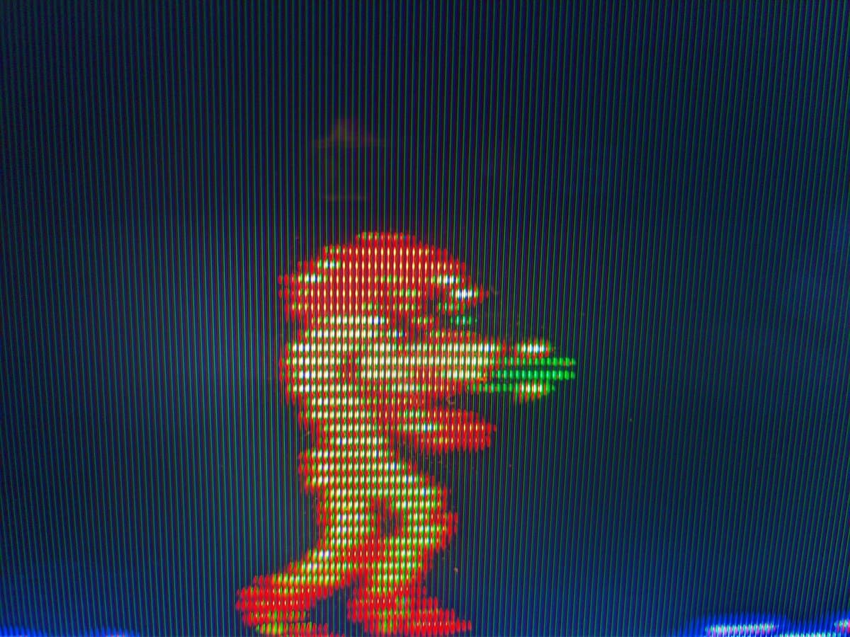 Metroid sprite displayed on Sony KV-29FX30E CRT via Famicom composite output, showing vibrant red and green pixels with scanlines visible.