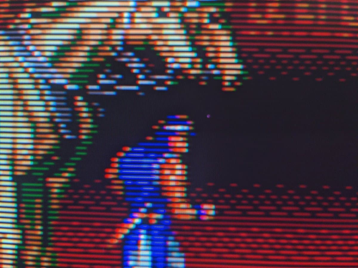 Close-up of Sony CPD-E430 CRT display showing RGB pixel structure with blue and red vertical lines against dark background, demonstrating screen functionality.