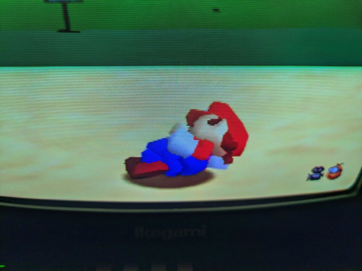 N64 displaying Super Mario 64 on Ikegami TM10-17RA monitor, showing shadow mask scanlines and tube neck glow during CRT testing.