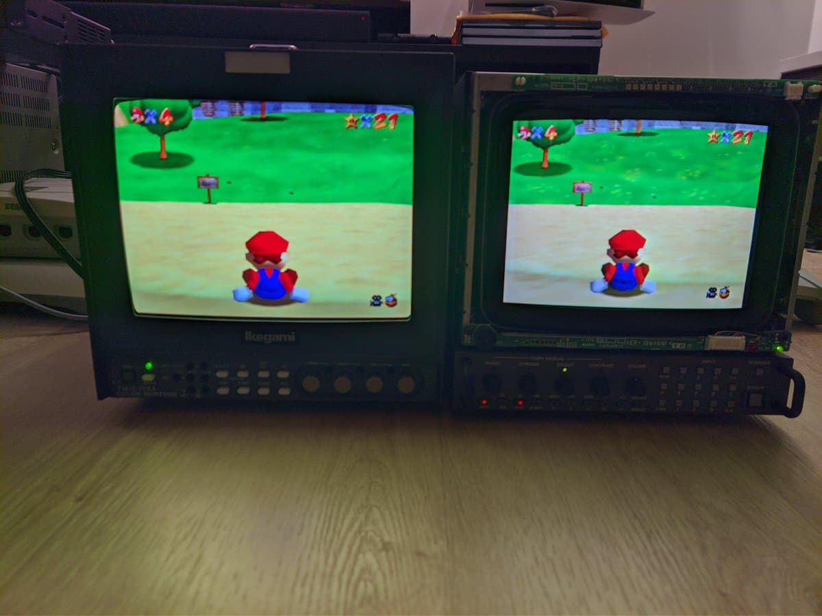 Two CRT monitors displaying Super Mario 64 side-by-side: Sony BVM-D9H5J (left) with aperture grille vs Ikegami (right) with shadow mask tube technology comparison.