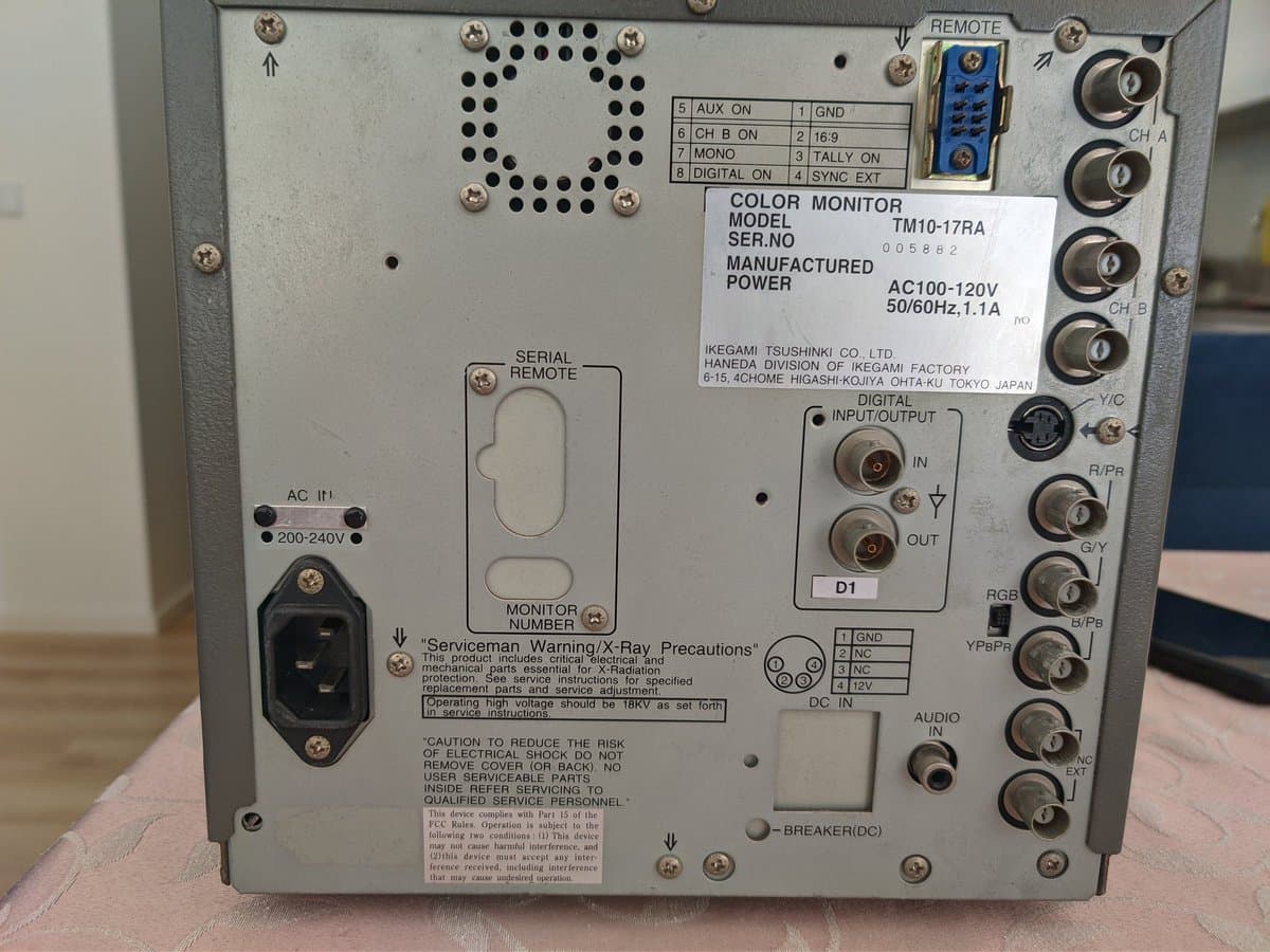 Ikegami TM10-17RA rear panel showing AC voltage selector (200-240V marked), serial remote connector, digital I/O, and audio connectors during European mains voltage reconfiguration mod.