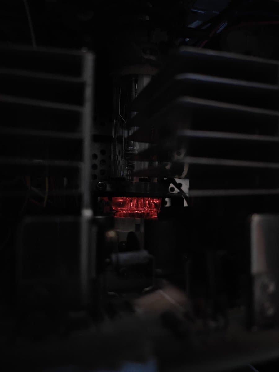 Glowing red CRT display element within Sony BVM-D14H1E monitor chassis during restoration testing and operation.