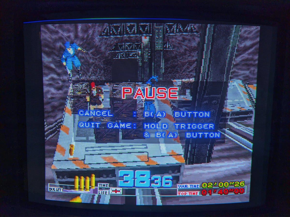 Time Crisis pause menu on CRT displaying GunCon test results with health bar, ammo counter, and game timer visible.