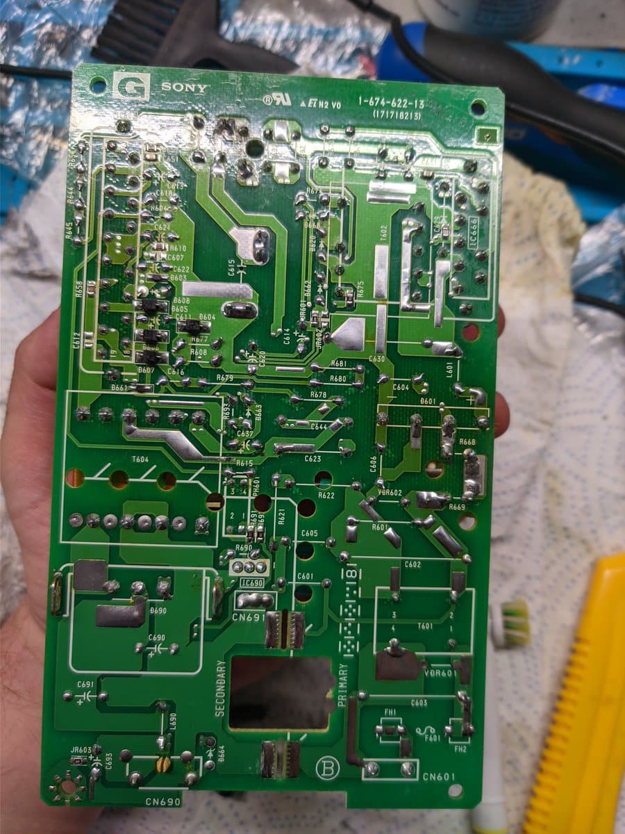 Sony BVM-D9H5J power supply board with partially replaced capacitors, cleaned rework joints, and component labeling visible during restoration maintenance.