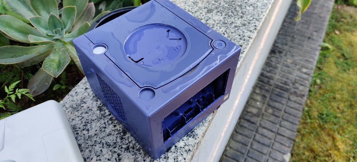 Blue Saturn Model 2 shell undergoing retrobritting treatment, showing discoloration and yellowing damage on top casing during restoration.