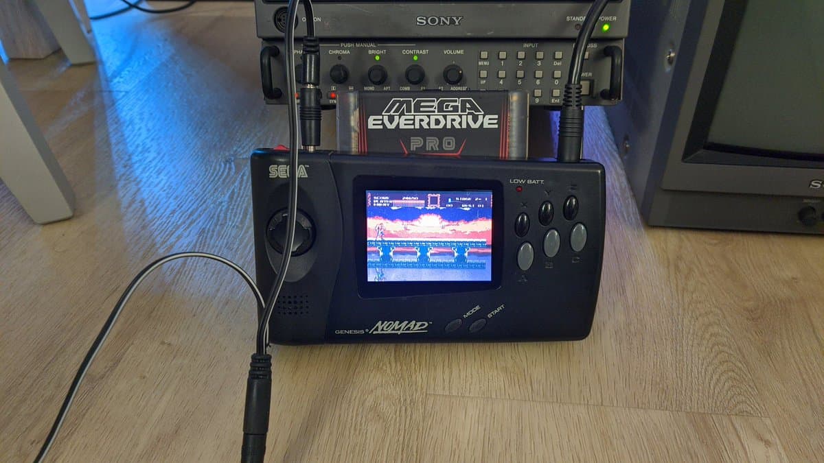 Sega Nomad displaying Castlevania gameplay, connected to Sony monitor and Mega Everdrive Pro cartridge for testing after electrolytic capacitor replacement.