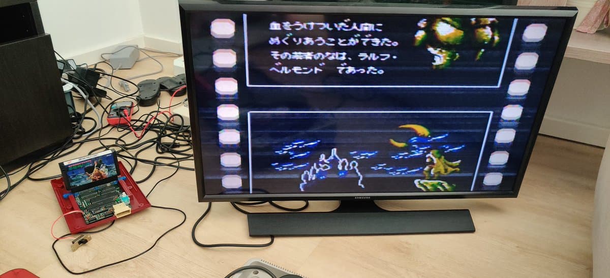 Red Famicom motherboard with composite mod connected to TV displaying Castlevania gameplay and Japanese text dialogue.