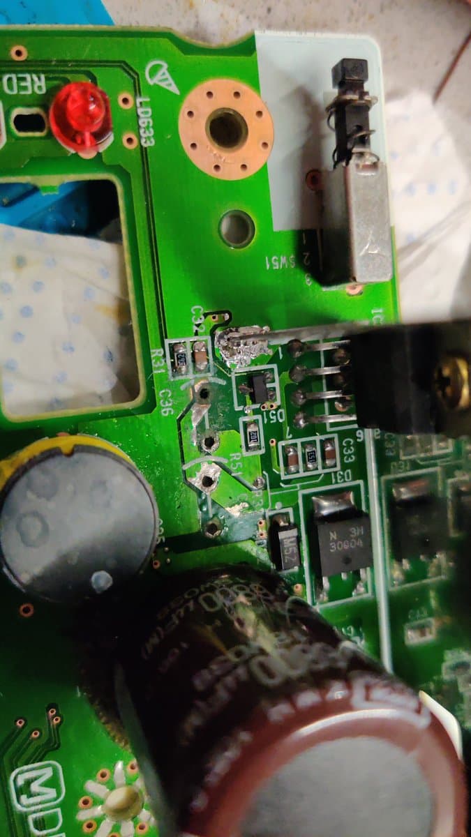 Panasonic FZ-1 PSU board showing ceramic capacitor C36 repair with soldered trace connections and replaced component near power delivery circuits.