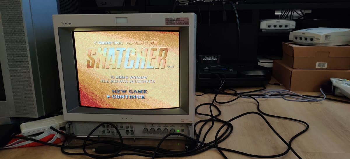 Sega Mega-CD 2 running Snatcher on Trinitron CRT; restoration complete with recapped board and region-free BIOS installed.