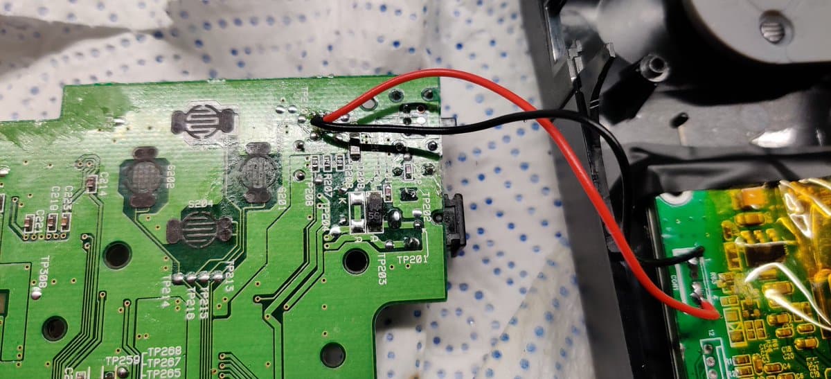 Sega Nomad power board showing replaced capacitors and cleaned solder joints around power input area during restoration.