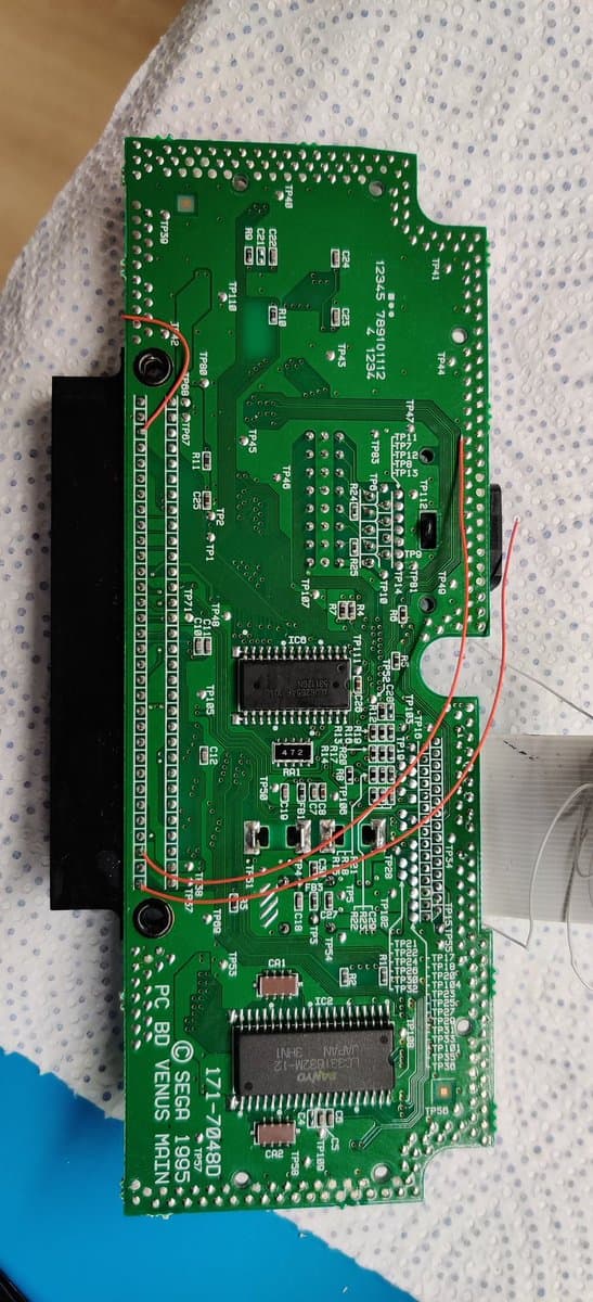 Sega Nomad PCB showing audio restoration mod with 10uF capacitors and 10k resistors soldered for Master System and Mega-CD audio channels.