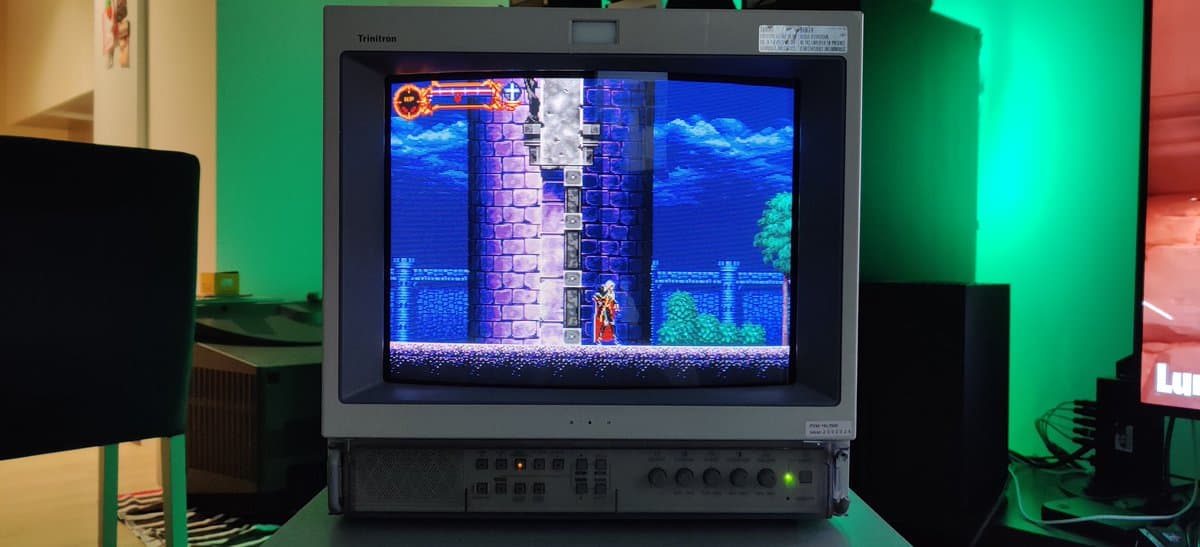 Castlevania: Symphony of the Night running on Sony PVM-14L2 CRT monitor displaying castle level with vibrant blue graphics and sprite character.