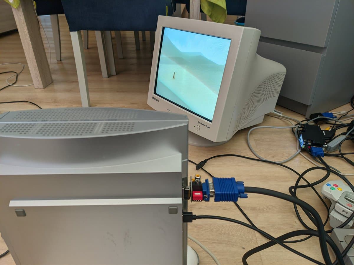 Samsung CRT monitor displaying Journey on PS3, with blue VGA adapter and cable connected to console on wooden desk.