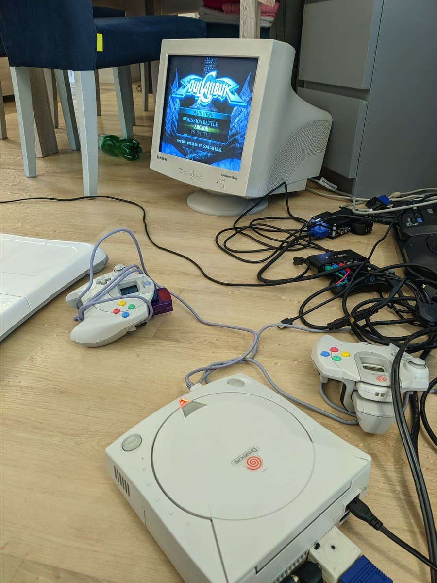 Dreamcast console with controllers connected to CRT monitor displaying Soul Calibur arcade menu screen during testing.
