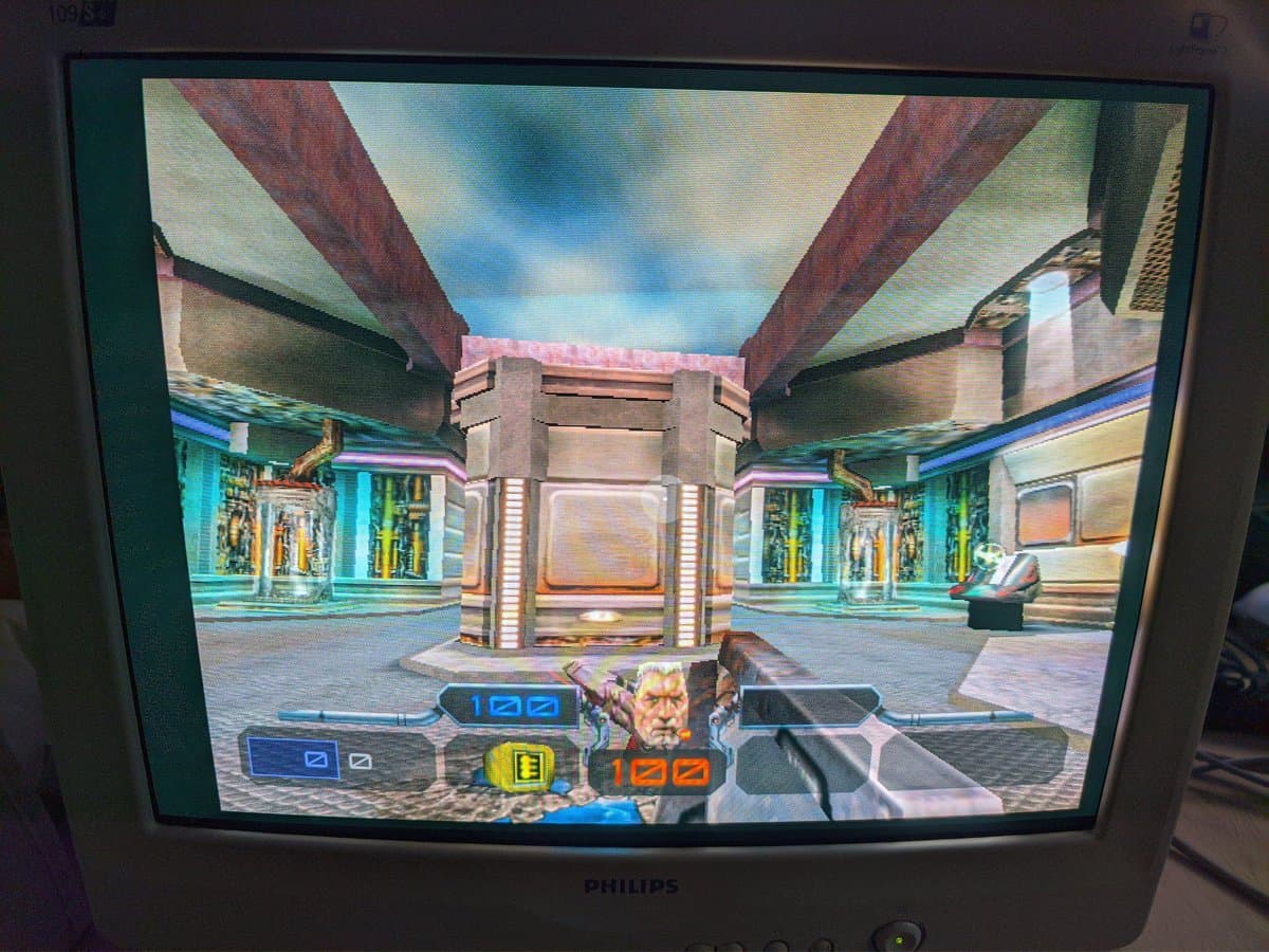 Quake III Arena running on repaired Philips 109S4 CRT displaying futuristic arena with aperture grille rendering visible.