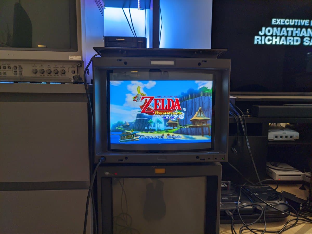 Sony BVM-D14H1E professional CRT monitor displaying Legend of Zelda Wind Waker HD at 1080i, surrounded by test equipment and cables in workspace.
