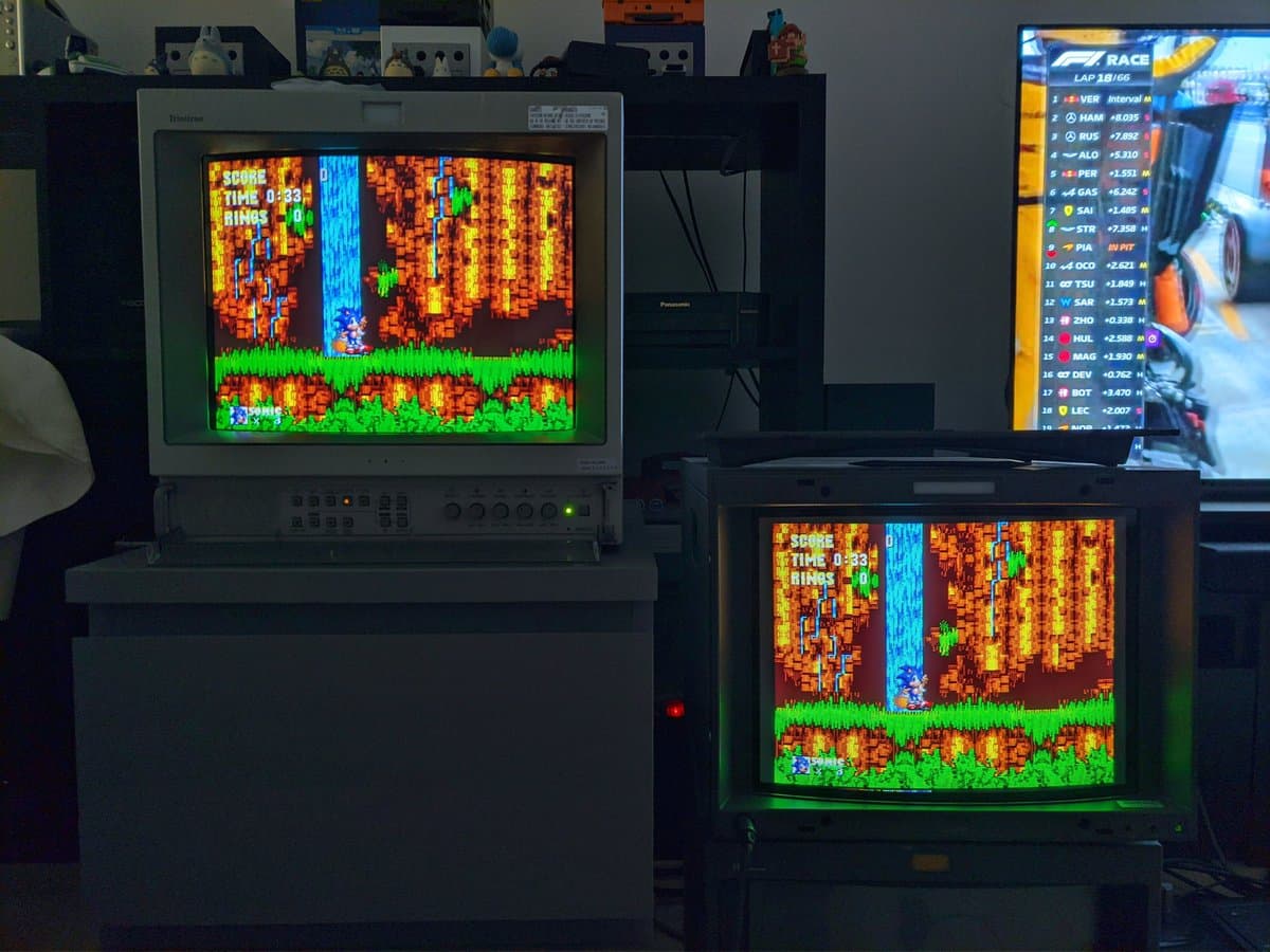 Two Sony BVM CRT monitors displaying Sonic the Hedgehog, daisy-chained together, showing identical arcade-quality video output on retro gaming setup.