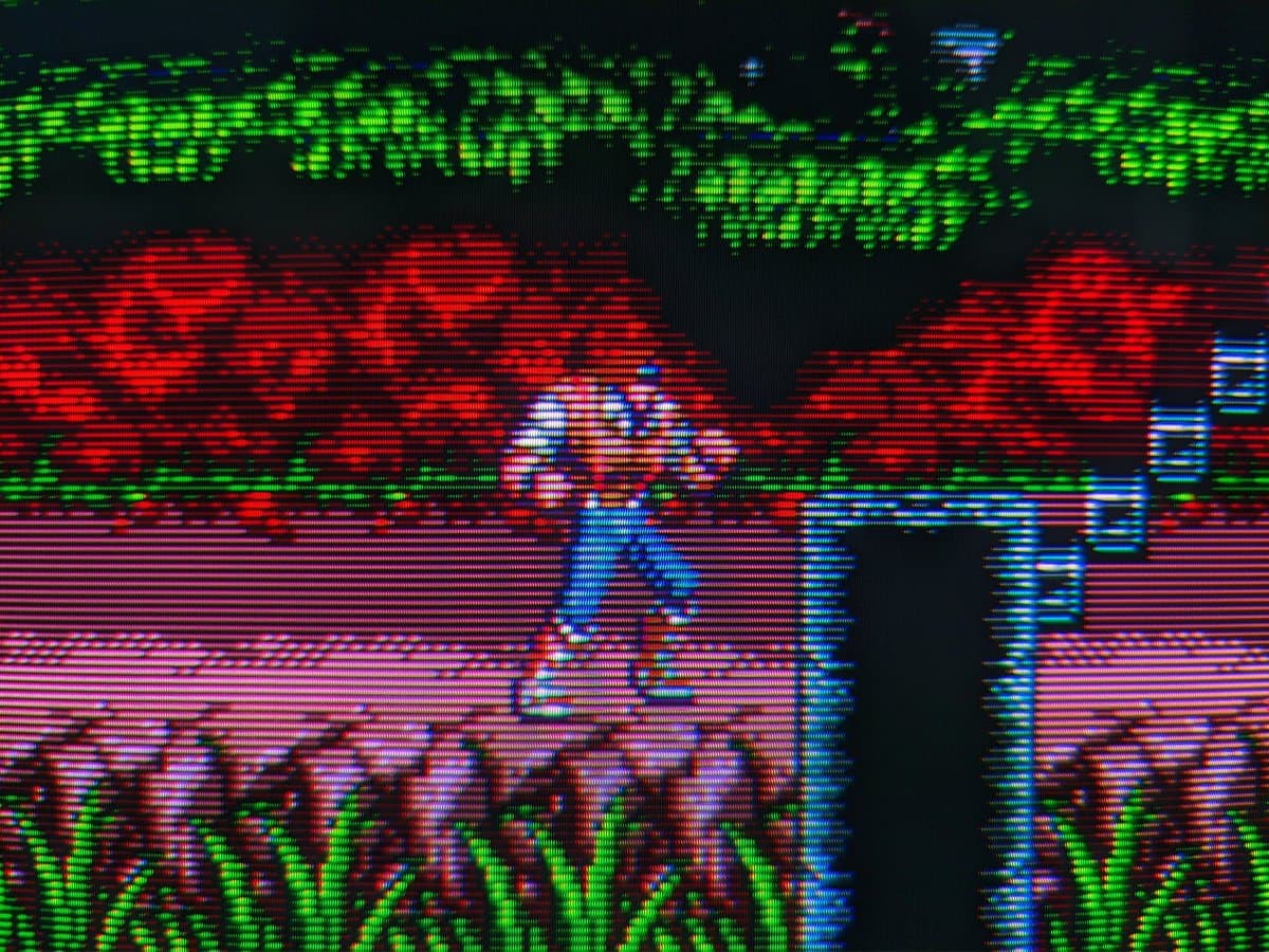 Sony PVM-14M4J displaying color bars test pattern with restored blue channel after reflowing tube connections; visible retrace lines remain.