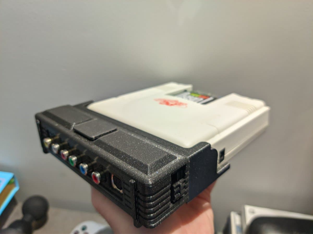 PC Engine AV adapter by PointerFunction showing RCA connectors and composite video output ports on black housing with white cartridge slot above.