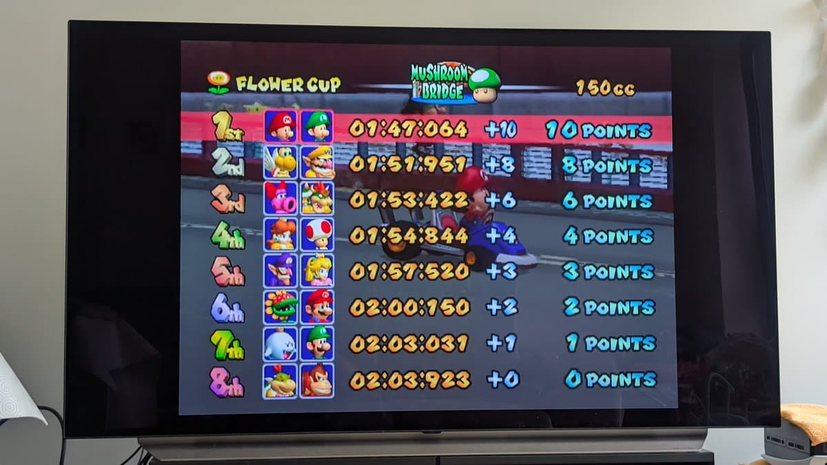 Mario Kart: Double Dash Flower Cup leaderboard on restored Panasonic Q, showing race times and points after optical drive repair and FlippyDrive installation.
