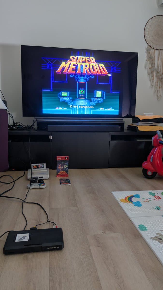 Super Metroid title screen on TV via Tink4K upscaler connected to recapped Super Famicom Jr., demonstrating composite video cleanup.