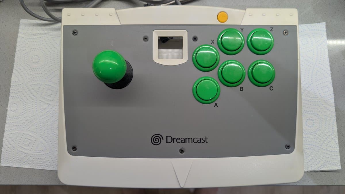 Dreamcast arcade stick with green buttons labeled X, Y, Z, A, B, C after cleaning and lubrication during VA0 refurbishment.