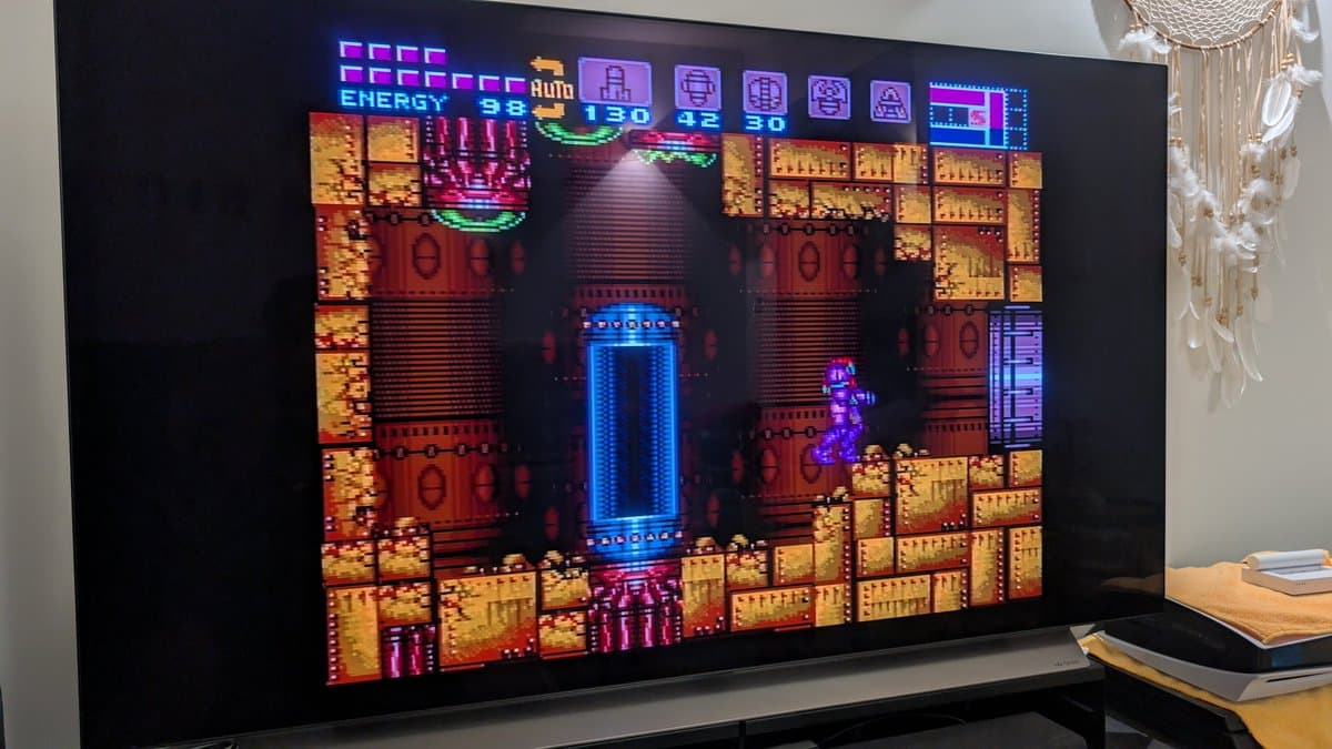 Super Metroid gameplay showing active cartridge with restored save file after battery and capacitor replacement maintenance.