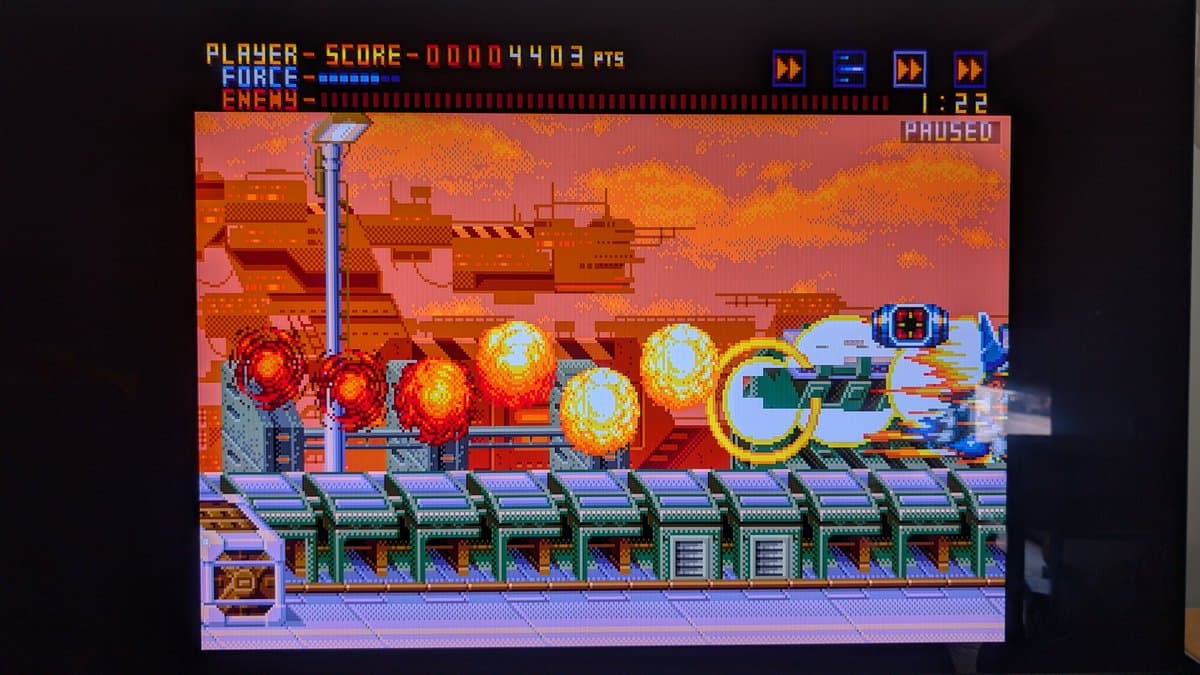 Sega Mega Drive running Alien Soldier, displaying colorful explosions and enemy projectiles during gameplay test after recapping and final repairs.