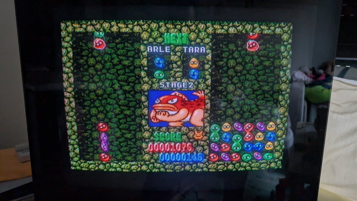 FM Towns Marty displaying Puyo Puyo Stage 2 with score and gameplay elements visible on CRT monitor post-capacitor replacement.