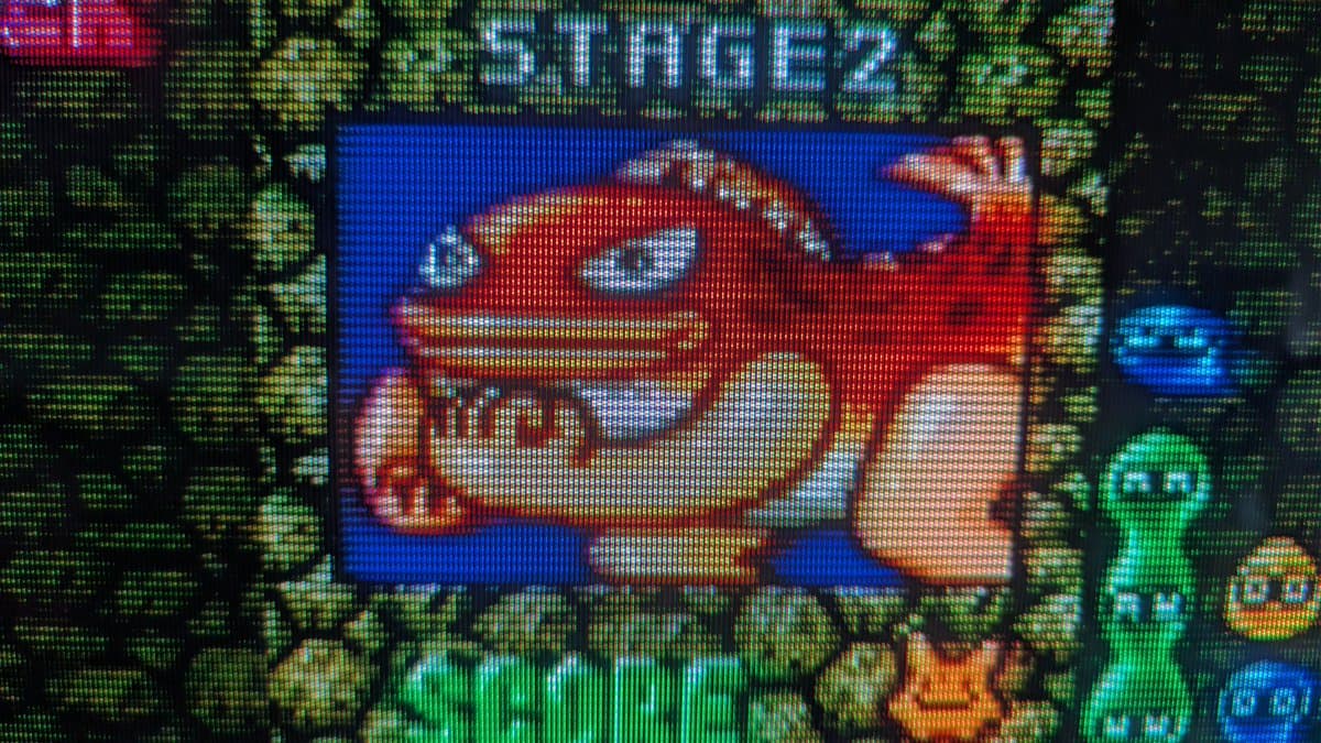 FM Towns Marty displaying Puyo Puyo 2 on CRT after capacitor replacement in PSU; floppy drive awaiting belt replacement.