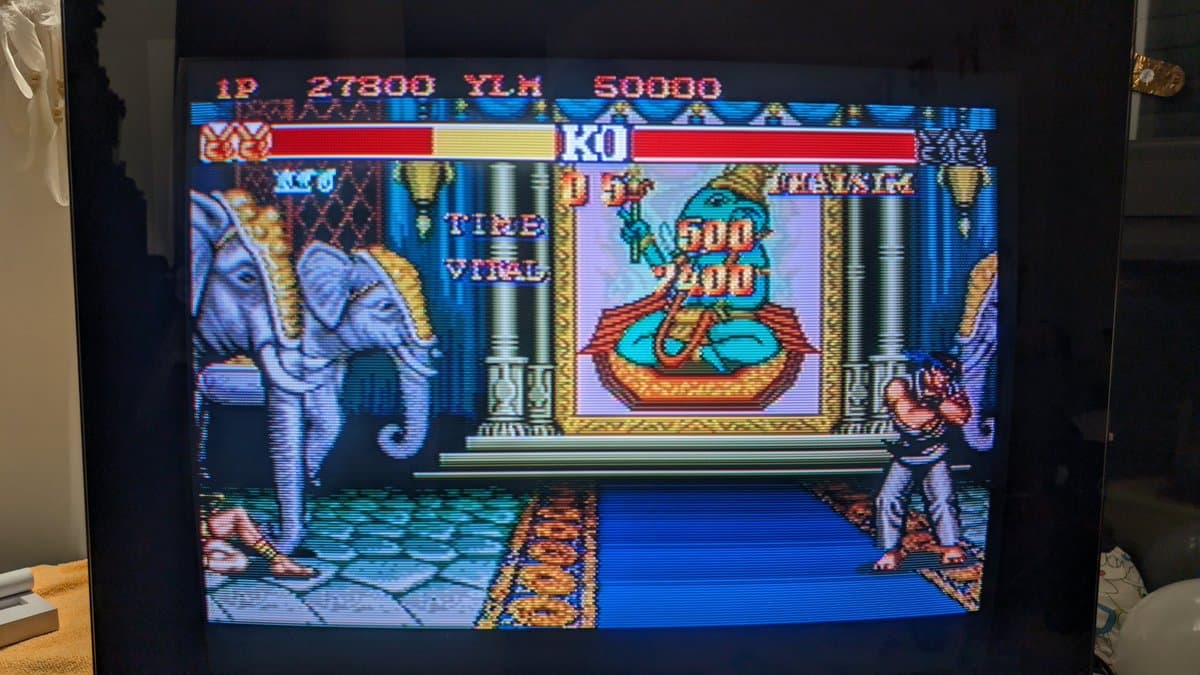 Street Fighter II gameplay on NEC PC Engine IFU-30 after recap repair, showing health bars and in-game action.
