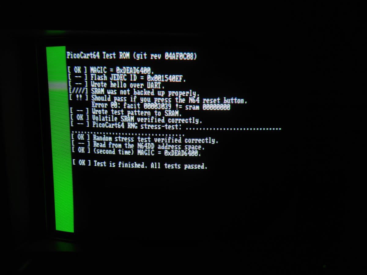 PicoCart64 Test ROM output on green CRT monitor showing successful test results with magic number, hash ID, and "All tests passed" message.