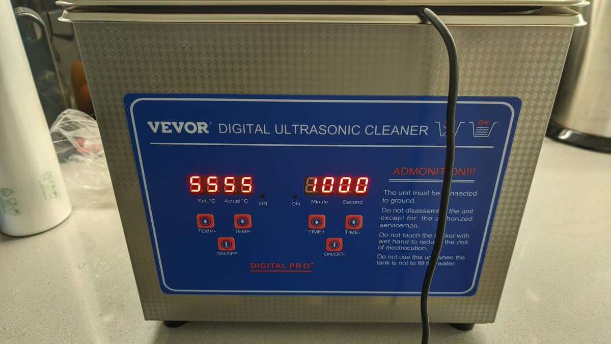 VEVOR digital ultrasonic cleaner with blue control panel showing temperature set to 55°C and 80 minute timer display, ready for PCB cleaning.