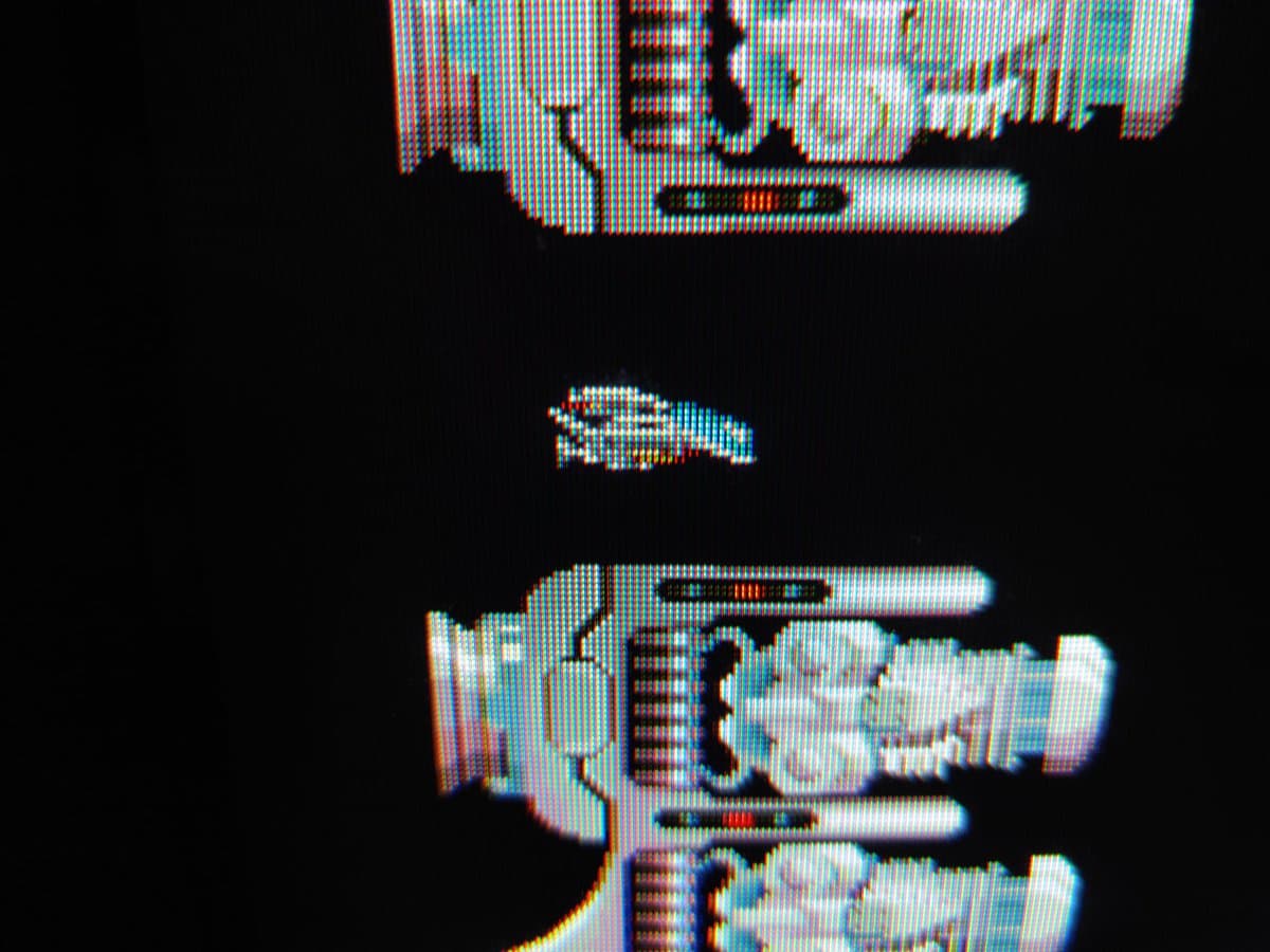 Restored PVM-9041Q displaying R-Type demo with crisp scanlines; vibrant RGB output shows successful recapping and deflection board repairs.