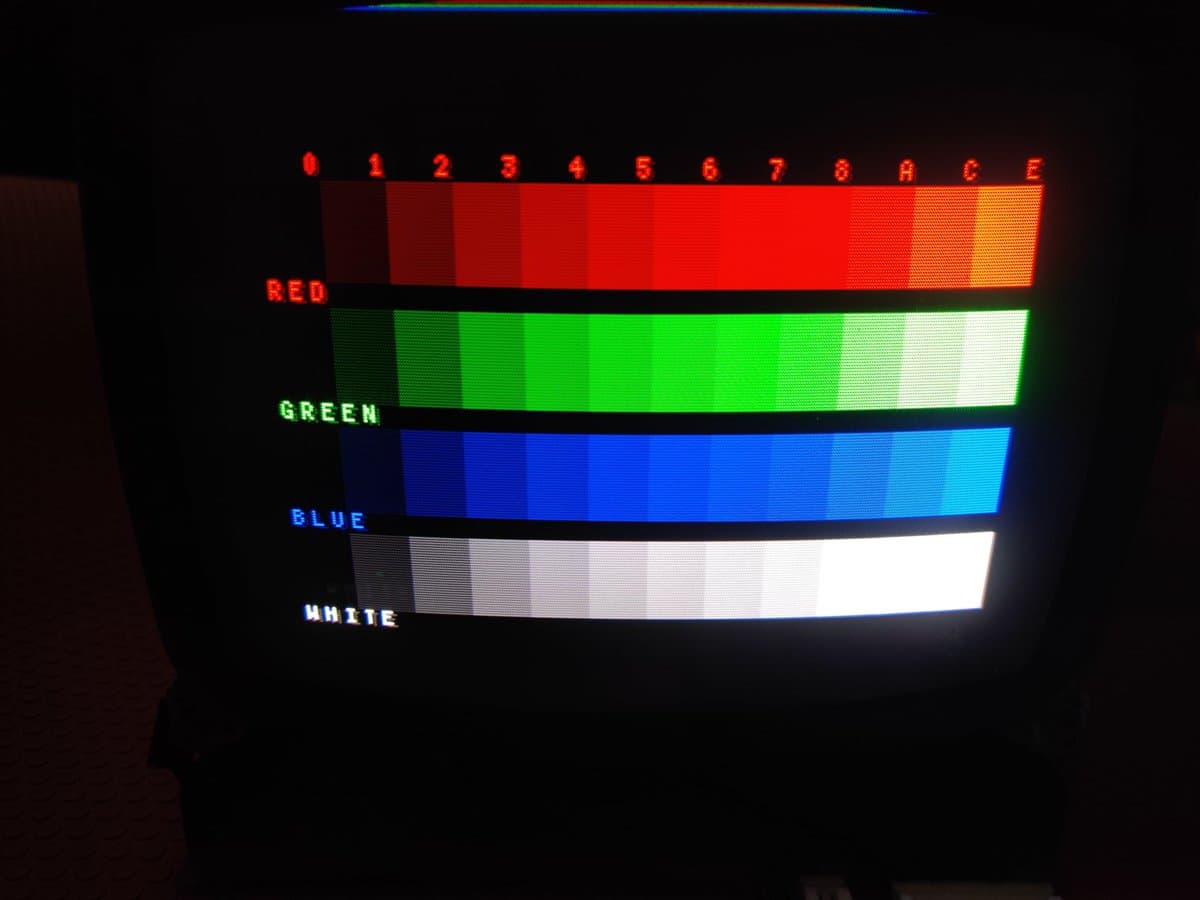 Ikegami HTM-1005RA2 CRT displaying color bars (red, green, blue, white) with numbered intensity levels 0-E, tube functioning properly post-transit.