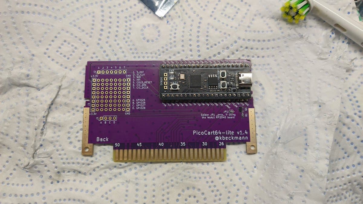 PicoCart64 lite v1.4 PCB back side showing Raspberry Pi Pico microcontroller with 16MB flash and cartridge edge connector pins.