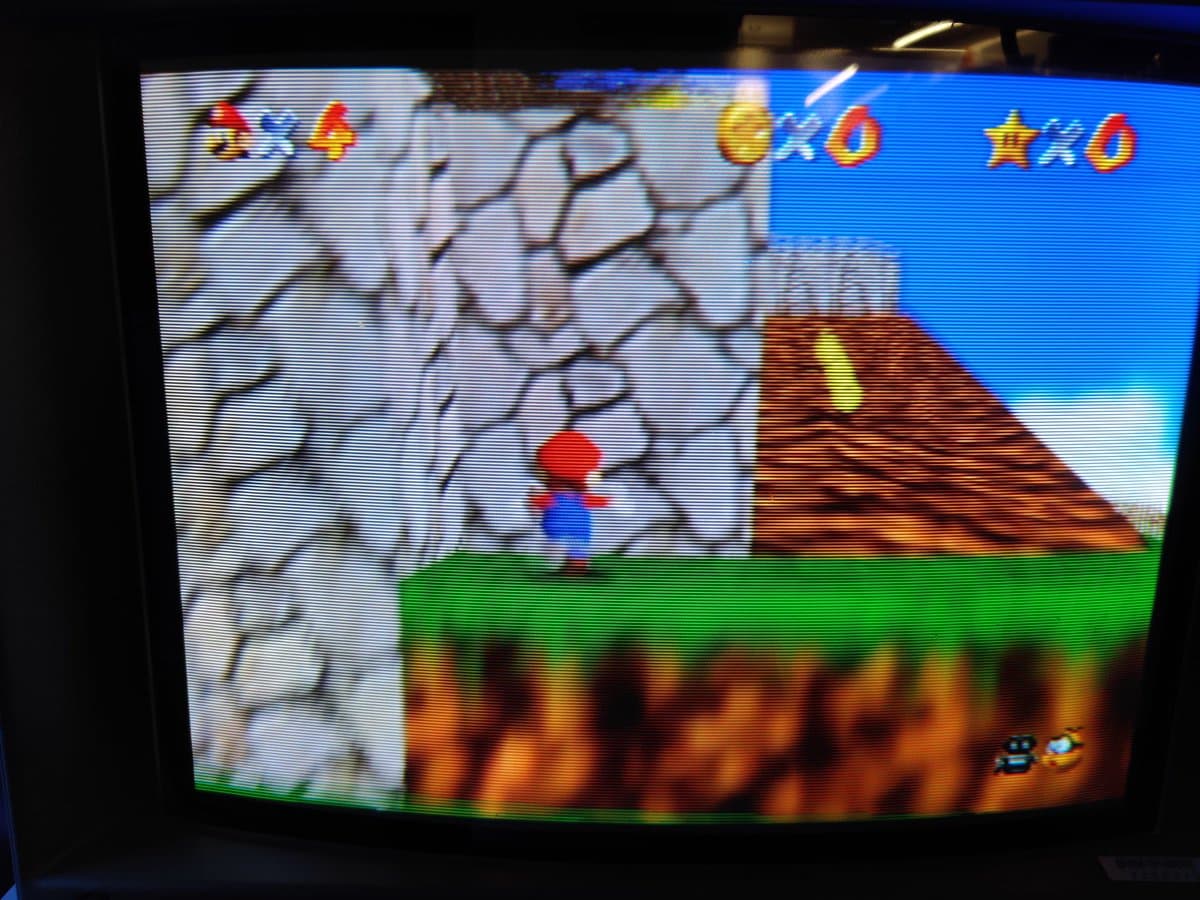 Super Mario 64 running on PicoCart64 lite flash cart with upgraded 16MB Pico, displaying game level with Mario character and collectibles.