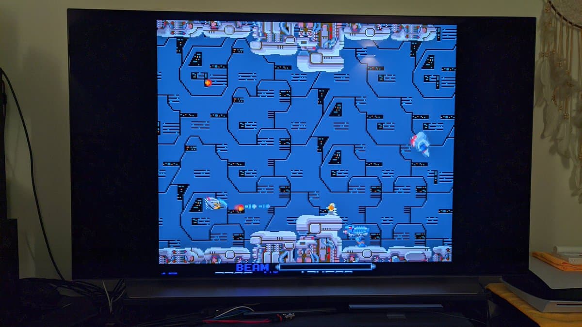Sharp X68000 Pro II displaying R-Type gameplay after successful restoration, showing blue sci-fi spaceship level with player aircraft mid-screen.