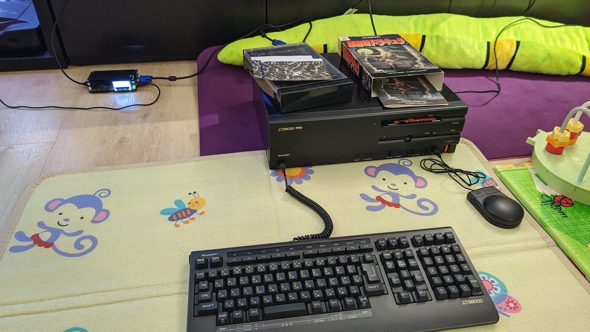 Sharp X68000 Pro II with Castlevania game discs displayed on test bench with keyboard, mouse, and microcontroller diagnostics setup.