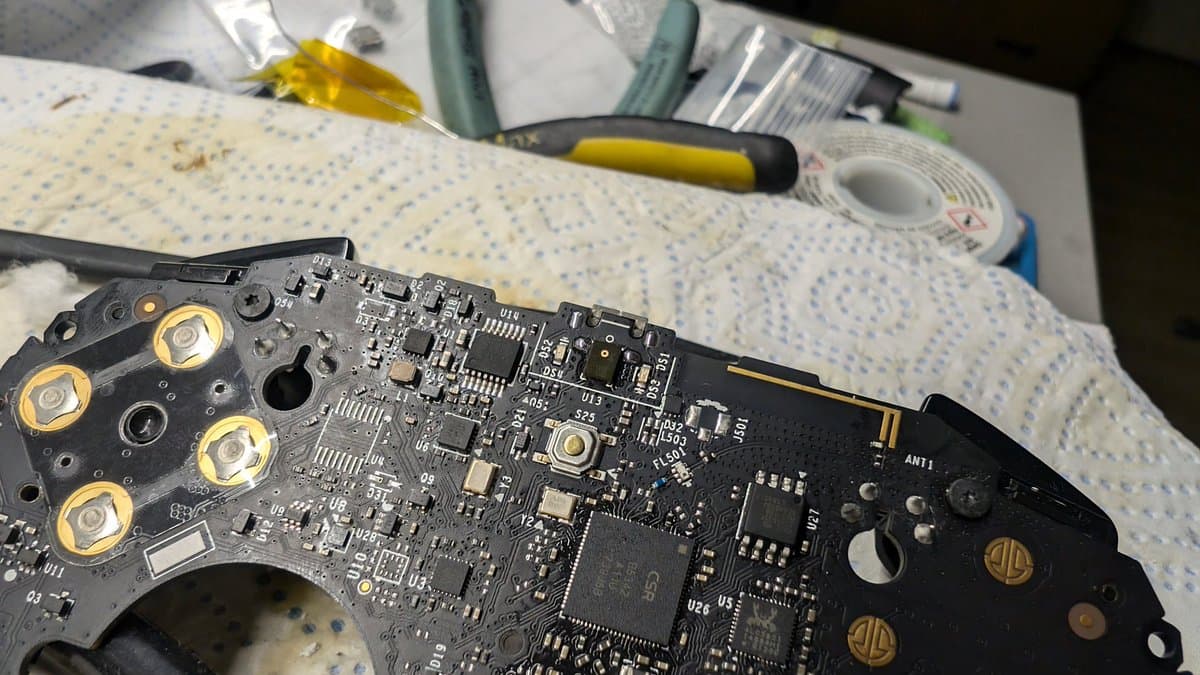 Nvidia Shield controller PCB with replaced USB port, soldering iron and tools visible on work surface with breadboard.