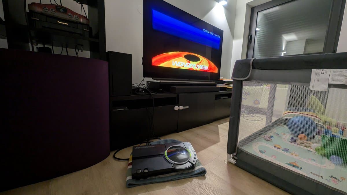 Sega Wondermega displaying startup freeze screen with internal cable connected, showing repair progress on restored console.