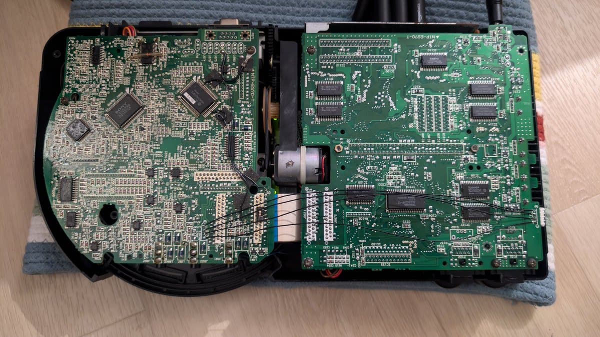 Two circuit boards from Sega Wondermega HWM-5010 laid flat, showing corrosion damage, missing components, and broken traces requiring restoration work.