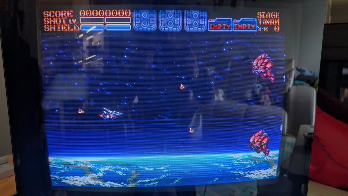 Road Avengers Mega-CD gameplay showing restored Wondermega with working LED indicators and blue starfield stage display.