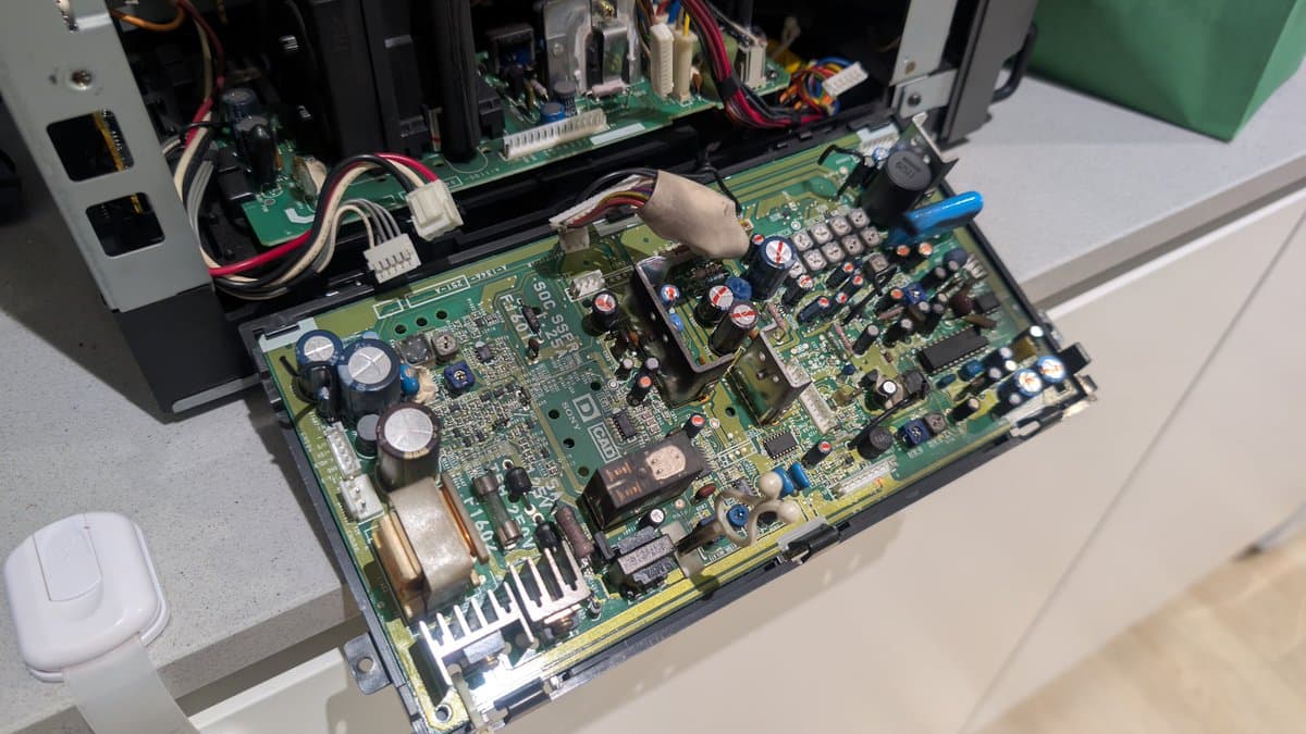 Sony PVM-9041Q deflection board laid out on workbench with components marked for recapping during restoration, alongside PSU and internal chassis visible.