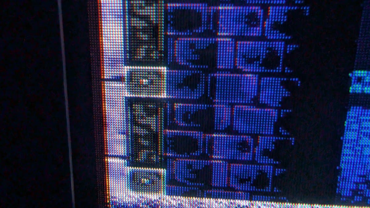 Sony PVM-9041Q CRT display showing blue and red test pattern during restoration, demonstrating color output after PSU recapping and deflection board repair.